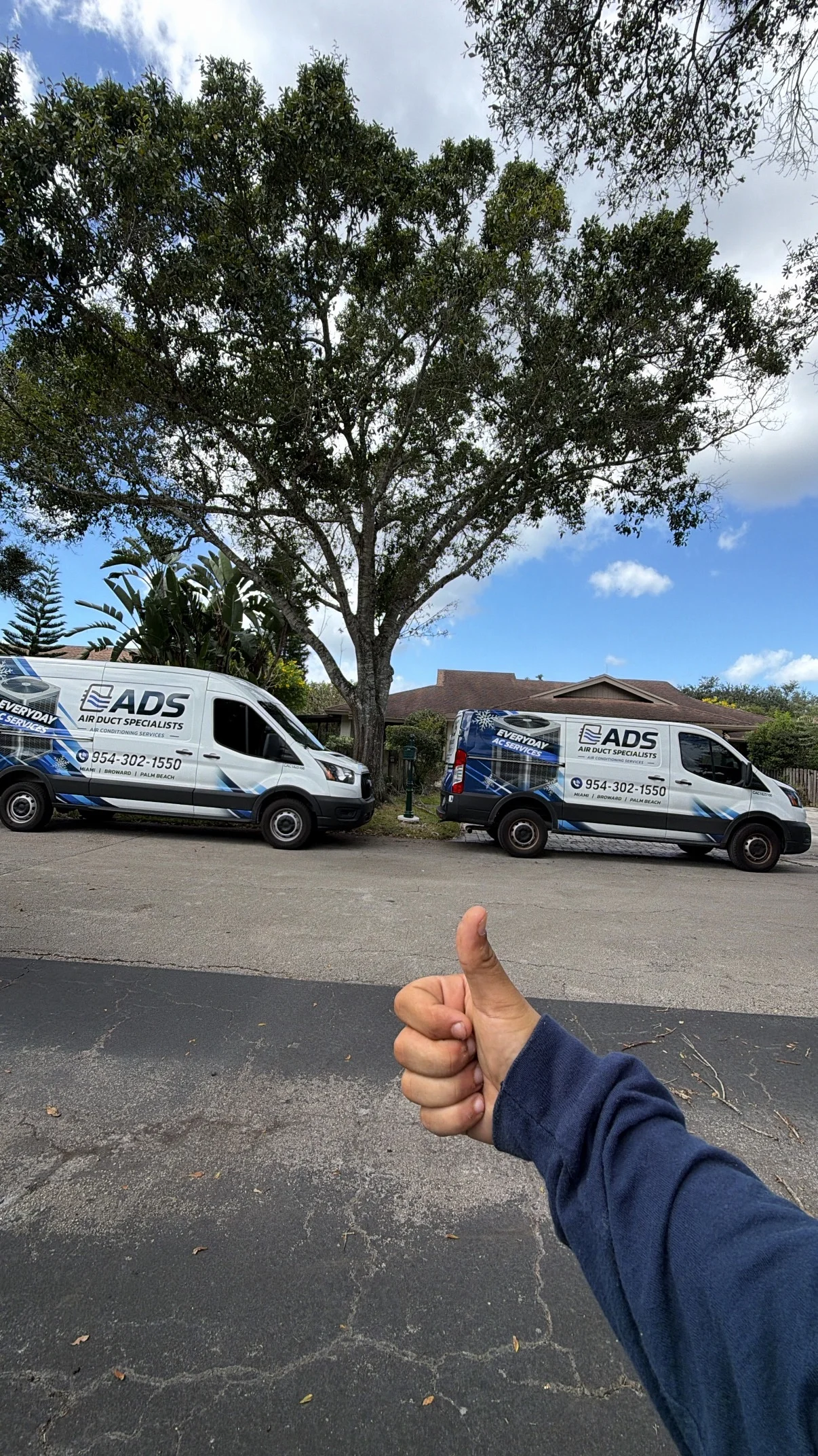 Two Air Duct Specialists service vans on site at a South Florida home — Air Duct Specialists LLC