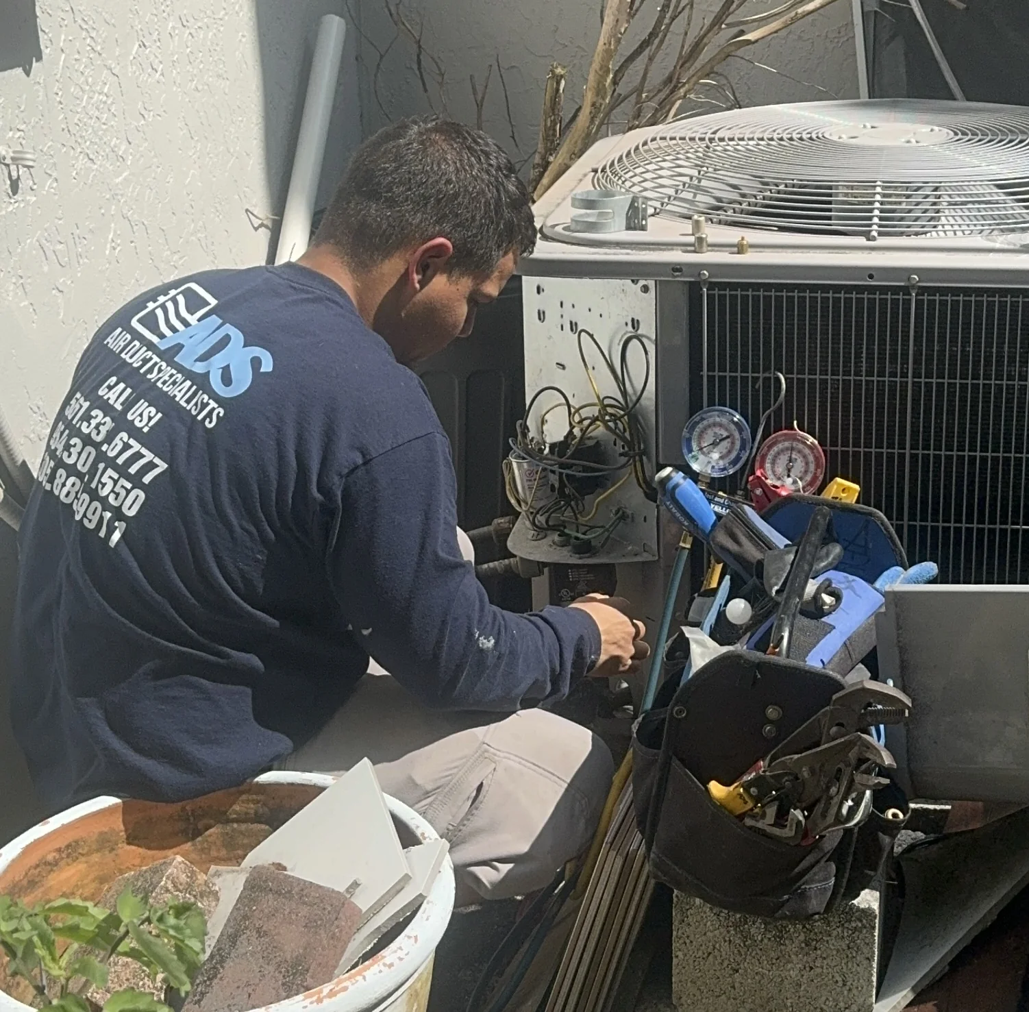 Air Duct Specialists LLC technician performing evaporator coil cleaning on Bryant by Carrier unit — Parkland FL