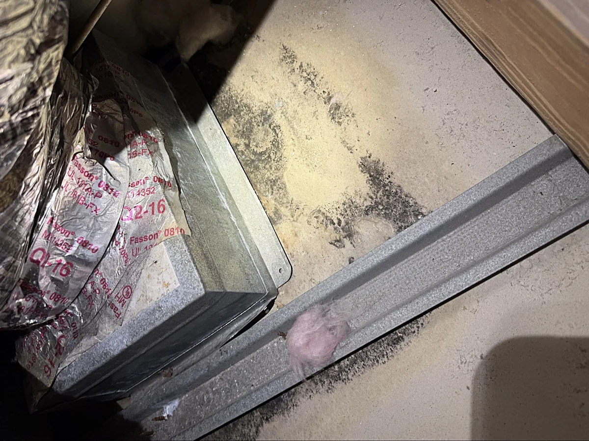 Black spotting on ceiling drywall next to a duct boot caused by condensation — Coral Gables estate