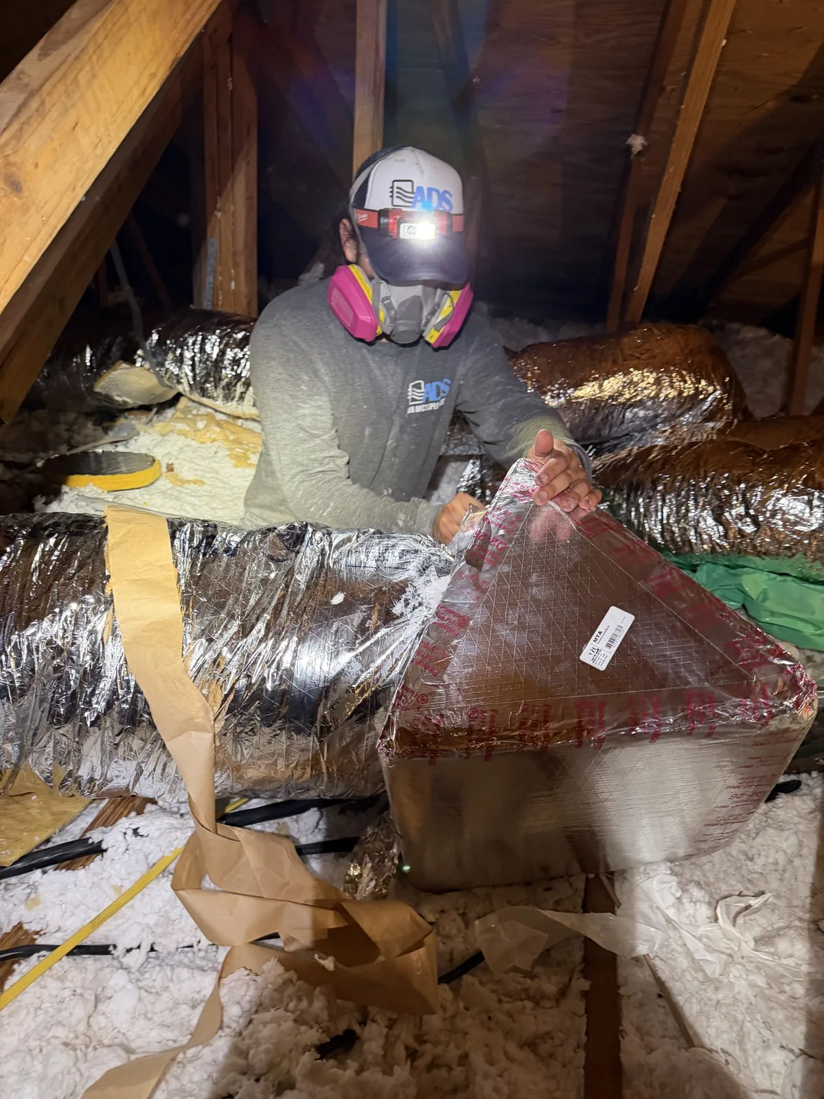 Technician installing new ductwork in a Plantation attic — Air Duct Specialists LLC