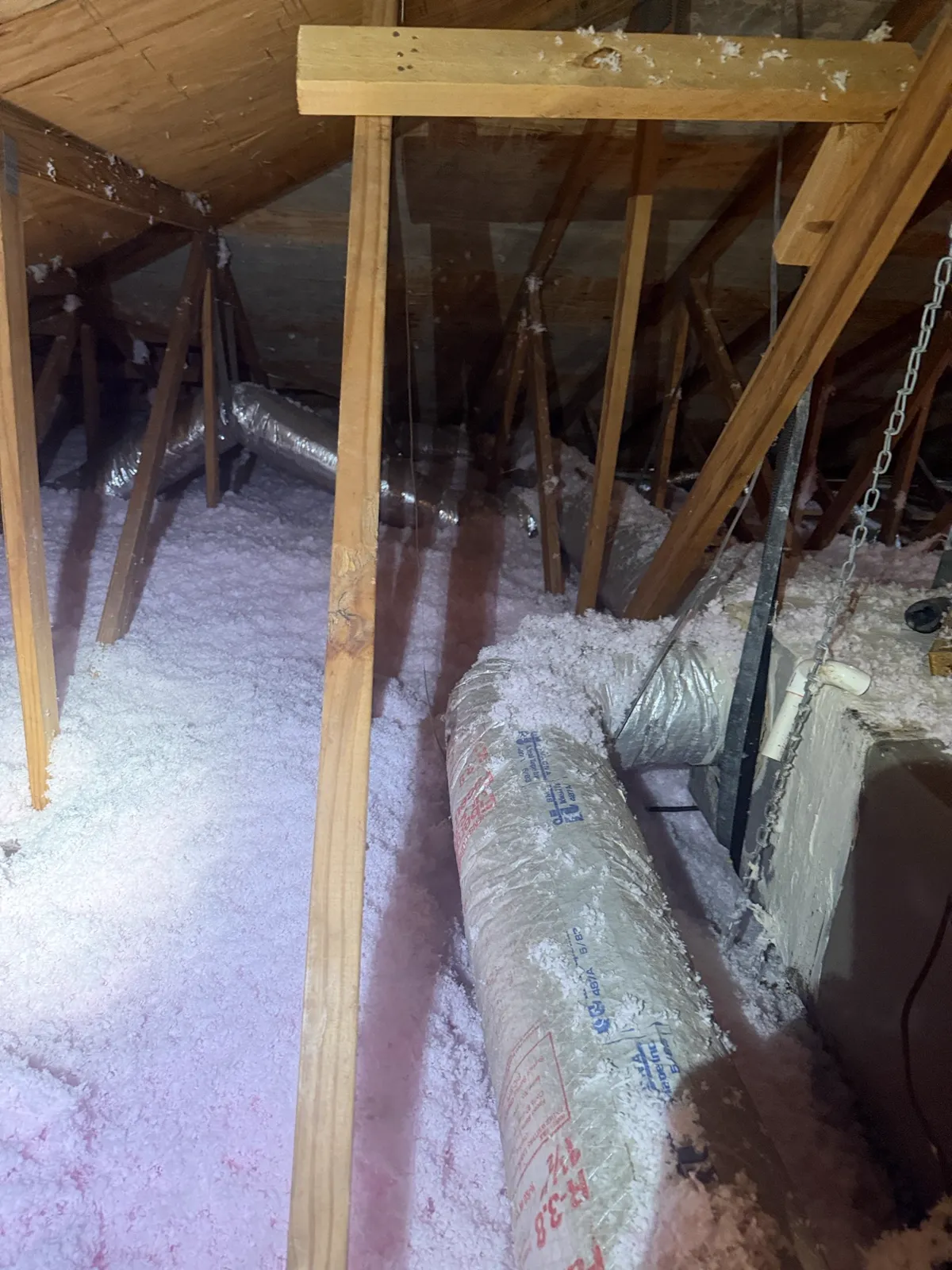 Flex duct routed with sharp up-and-down bends in a South Florida attic — improper duct design causing airflow loss — Air Duct Specialists LLC