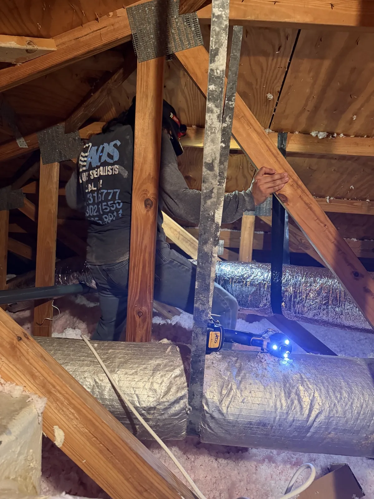 New duct runs hung with straps in a South Florida attic, straight and supported — Air Duct Specialists LLC