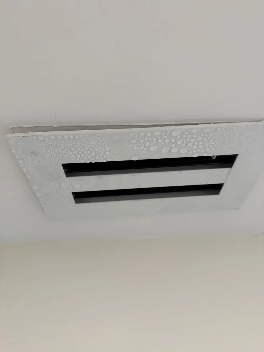 Air vent covered in condensation droplets — a sweating vent in a South Florida home